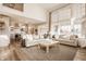 Spacious living room with soaring ceilings, large windows, and an open floor plan to the kitchen at 15655 Woodford Dr, Westfield, IN 46074
