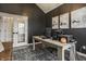 Stylish home office with dark walls, a vaulted ceiling, and modern furnishings at 15655 Woodford Dr, Westfield, IN 46074