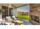 Cozy outdoor living space featuring a brick fireplace, comfortable seating, and a view of the backyard at 15655 Woodford Dr, Westfield, IN 46074