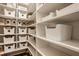 Walk-in pantry with custom shelving and ample storage space at 15655 Woodford Dr, Westfield, IN 46074