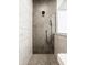 Contemporary shower boasts sleek gray tiling, a modern showerhead, and glass enclosure at 15655 Woodford Dr, Westfield, IN 46074