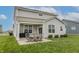 Spacious backyard with a patio dining set and view of the home's exterior at 16080 Cabin Hill Dr, Noblesville, IN 46060