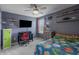 Stylish bedroom with gray walls, carpet, ceiling fan, and organized shelving showcasing a creative display of toys and decor at 16080 Cabin Hill Dr, Noblesville, IN 46060