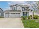 Beautiful two-story home with a three-car garage and well-manicured lawn and landscaping at 16080 Cabin Hill Dr, Noblesville, IN 46060