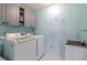 Well-lit laundry room with gray cabinetry and modern washer and dryer at 16080 Cabin Hill Dr, Noblesville, IN 46060