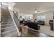 Spacious living room with a staircase and a view of the open-concept kitchen at 16080 Cabin Hill Dr, Noblesville, IN 46060