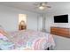 Spacious main bedroom with carpet, ceiling fan, flat screen tv, and colorful comforter at 16080 Cabin Hill Dr, Noblesville, IN 46060