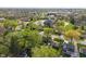 Aerial view of a neighborhood with homes and mature trees, showcasing the community layout and nearby buildings at 165 N 9Th St, Zionsville, IN 46077