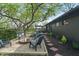 Large backyard with firepit, patio, exterior lighting and mature trees at 165 N 9Th St, Zionsville, IN 46077