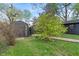 Well-maintained backyard with a storage shed, mature trees, and a grassy lawn at 165 N 9Th St, Zionsville, IN 46077