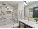 Elegant bathroom features marble tile shower with gold fixtures, a modern vanity and stylish lighting at 165 N 9Th St, Zionsville, IN 46077