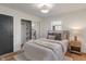 Comfortable bedroom with neutral decor, closet with sliding mirror door, hardwood floors and ample natural light at 165 N 9Th St, Zionsville, IN 46077