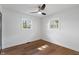 Bright bedroom with hardwood floors, ceiling fan, and two windows at 165 N 9Th St, Zionsville, IN 46077