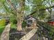 A small cottage with a garden, decorative door, and stone pathway in the back at 165 N 9Th St, Zionsville, IN 46077