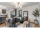 Bright dining room features a dark wood table, stylish lighting, and an open floor plan leading to the kitchen at 165 N 9Th St, Zionsville, IN 46077