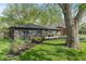 Landscaped home featuring an expansive yard, dark exterior, and manicured flower beds at 165 N 9Th St, Zionsville, IN 46077
