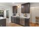 Kitchen area showcasing elegant marble backsplash, dark wood cabinets, stainless steel appliances and gold fixtures at 165 N 9Th St, Zionsville, IN 46077