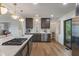 Modern kitchen boasts stainless steel appliances, marble countertops, and sleek dark cabinetry with stylish gold fixtures at 165 N 9Th St, Zionsville, IN 46077