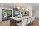 Kitchen island with barstool seating, gas cooktop, and marble countertop, is perfect for entertaining at 165 N 9Th St, Zionsville, IN 46077