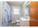 Bathroom featuring a shower with curtain, toilet, sink and a vanity at 166 N Post Rd, Indianapolis, IN 46219