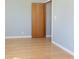 Bedroom with wood floors and base trim and a view into the closet at 166 N Post Rd, Indianapolis, IN 46219