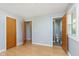 Bright bedroom with wood floors, wood doors, and ensuite bath and closet at 166 N Post Rd, Indianapolis, IN 46219