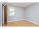 Bright bedroom with hardwood floors, a window with view, and fresh neutral color scheme at 166 N Post Rd, Indianapolis, IN 46219