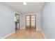 Hardwood floored dining area with gray walls and double doors leading to the backyard at 166 N Post Rd, Indianapolis, IN 46219