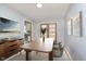 Inviting dining area with modern lighting, hardwood flooring, and access to the backyard at 166 N Post Rd, Indianapolis, IN 46219