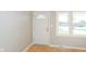 Bright entryway featuring a white door, trim, light gray walls and hardwood floors at 166 N Post Rd, Indianapolis, IN 46219