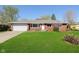 Charming brick home with a well-manicured lawn and an attached two car garage at 166 N Post Rd, Indianapolis, IN 46219