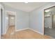 Inviting hallway with hardwood floors and neutral paint, leading to a bright front door at 166 N Post Rd, Indianapolis, IN 46219