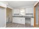 Contemporary kitchen with white cabinetry, granite counters, and stainless steel sink with window at 166 N Post Rd, Indianapolis, IN 46219