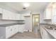 Well-lit kitchen showcasing white cabinets, granite countertops, and updated stainless steel sink at 166 N Post Rd, Indianapolis, IN 46219