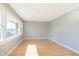 Bright living room featuring wood floors, neutral gray walls, and a sun-drenched window at 166 N Post Rd, Indianapolis, IN 46219