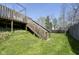 Back yard with a deck staircase and a grassy lawn, perfect for outdoor enjoyment at 1809 Ernest Ct, Indianapolis, IN 46234