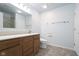 Bathroom featuring a single sink vanity, white toilet and framed mirror above at 1809 Ernest Ct, Indianapolis, IN 46234