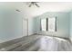 Neutral bedroom with gray flooring, vaulted ceilings, a ceiling fan, and two windows for natural light at 1809 Ernest Ct, Indianapolis, IN 46234