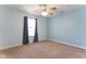 Bedroom featuring blue paint, tan carpet, and a window with curtains at 1809 Ernest Ct, Indianapolis, IN 46234