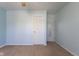 Bedroom with blue walls and carpet featuring ceiling fan and doors at 1809 Ernest Ct, Indianapolis, IN 46234