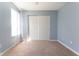 Bedroom featuring window, tan carpet, and sliding door closet at 1809 Ernest Ct, Indianapolis, IN 46234