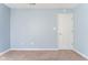 Bedroom featuring blue paint, tan carpet, and a white door at 1809 Ernest Ct, Indianapolis, IN 46234