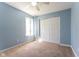 Bedroom with blue walls, carpet, and slider closet, offering a calming and serene space at 1809 Ernest Ct, Indianapolis, IN 46234