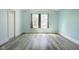 Bright bedroom with two windows, gray plank flooring, and a ceiling fan at 1809 Ernest Ct, Indianapolis, IN 46234