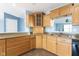 Corner view of the kitchen, featuring stainless steel sink, black dishwasher, and wooden cabinets at 1809 Ernest Ct, Indianapolis, IN 46234