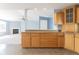 Spacious kitchen with wooden cabinets, granite countertop, and an open view to the living room at 1809 Ernest Ct, Indianapolis, IN 46234