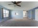 Spacious living room featuring light blue walls, neutral carpet, and a ceiling fan at 1809 Ernest Ct, Indianapolis, IN 46234