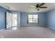 Open living room with neutral carpet, a ceiling fan, and an open front door at 1809 Ernest Ct, Indianapolis, IN 46234