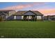 Spacious backyard featuring lush green grass, a covered patio, and mature trees for added privacy at 1973 Mobley Dr, Westfield, IN 46074