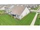 Back of home featuring covered porch, manicured landscaping, and lush green lawn at 1973 Mobley Dr, Westfield, IN 46074